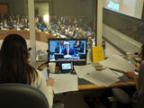 Small 640px an image of secretary kerry is seen on a tv screen in a translators  booth